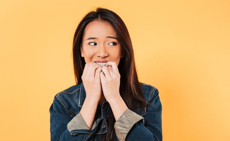 Wanita cantik dengan senyum menawan menunjukkan cara merapikan gigi dengan tangan